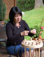 Jan Buday working on a round braiding loom called a  marudai.