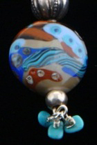 Kumihimo traditional kusari-tsunagi silk braid using 8 tama or bobbins, silver findings, amber, silver and turquoise beads. Flameworked Moretti glass focal bead.