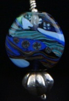 Kumihimo traditional “Yatsu-Oimatsu” silk braid using 16 “tama” or bobbins. Silver findings, beads, flameworked Moretti glass focal bead.